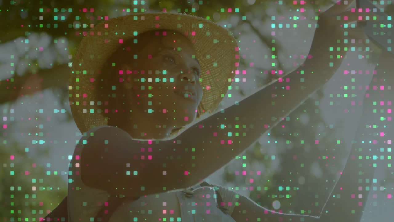 Reaching up, person wearing hat with colorful digital data animation overlay