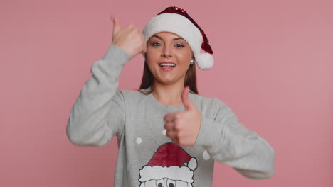 christmas woman raises thumbs up agrees or gives positive reply recommends advertisement likes good