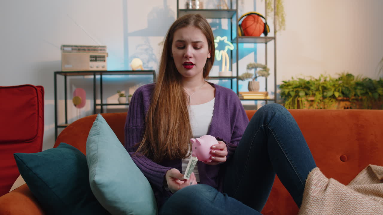 Poor young woman holding piggybank and one dollar banknote financial crisis bankruptcy poverty