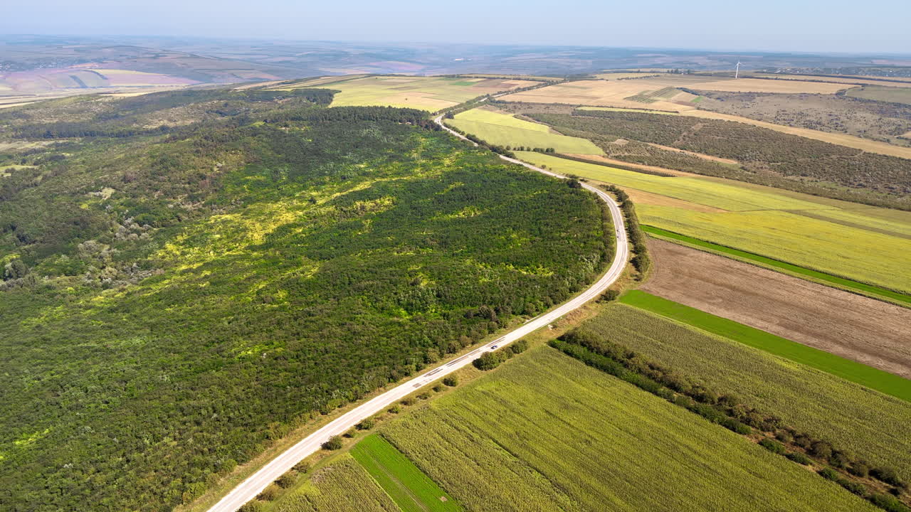 Aerial drone view of nature in Moldova. Highway, wide fields, forest