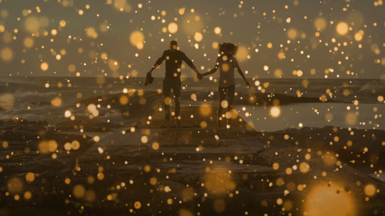 Couple running while holding hands along concrete pier by sea at sunset, with bokeh showing health