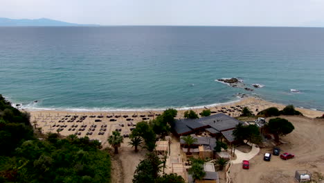 cinematic aerial shot of almyra luxury resort, golden beach and azure ocean