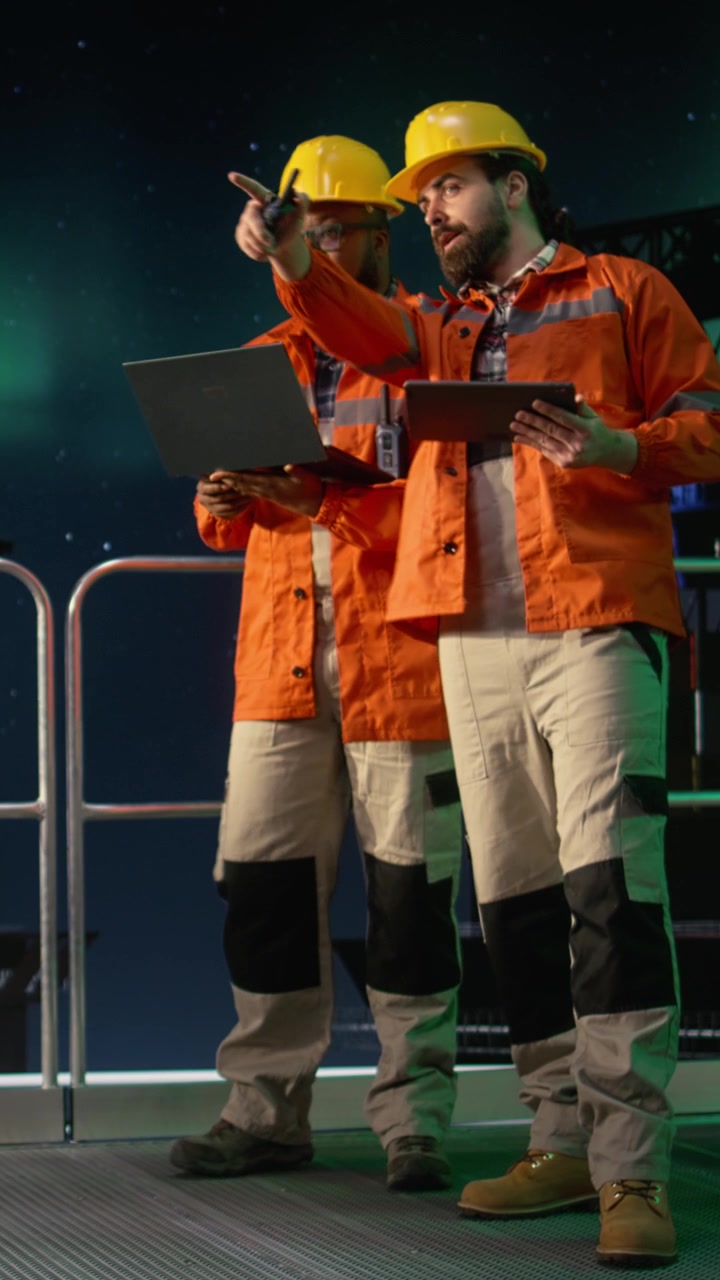 Vertical video Analyzing oil crisis logistics, laptop and drilling barge engineering team