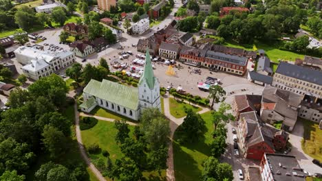 aerial view of dobele latvia with līgo festival market and white church, europe