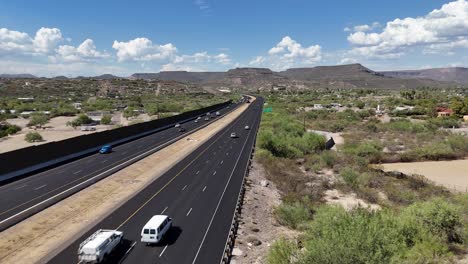 drone rising above interstate highway 17 in black canyon city arizona, cars driving on highway in the desert