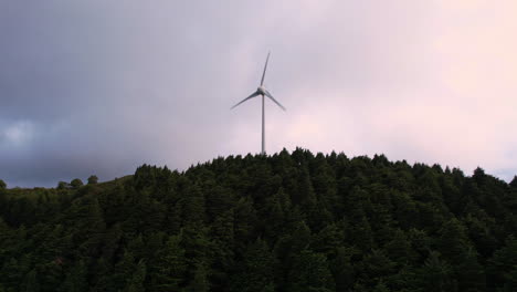 windmill in lush mountainous terrain.