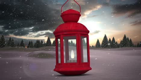 Red-christmas-lamp-against-snow-falling-over-multiple-trees-on-winter-landscape