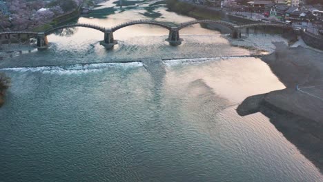 Kintai-Bridge-at-Sunrise-in-Spring,-Aerial-Pullback-Shot-4k