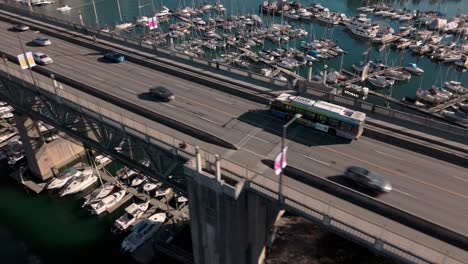 aerial burrard st bridge tracking translink bus into downtown vancouver - autumn day