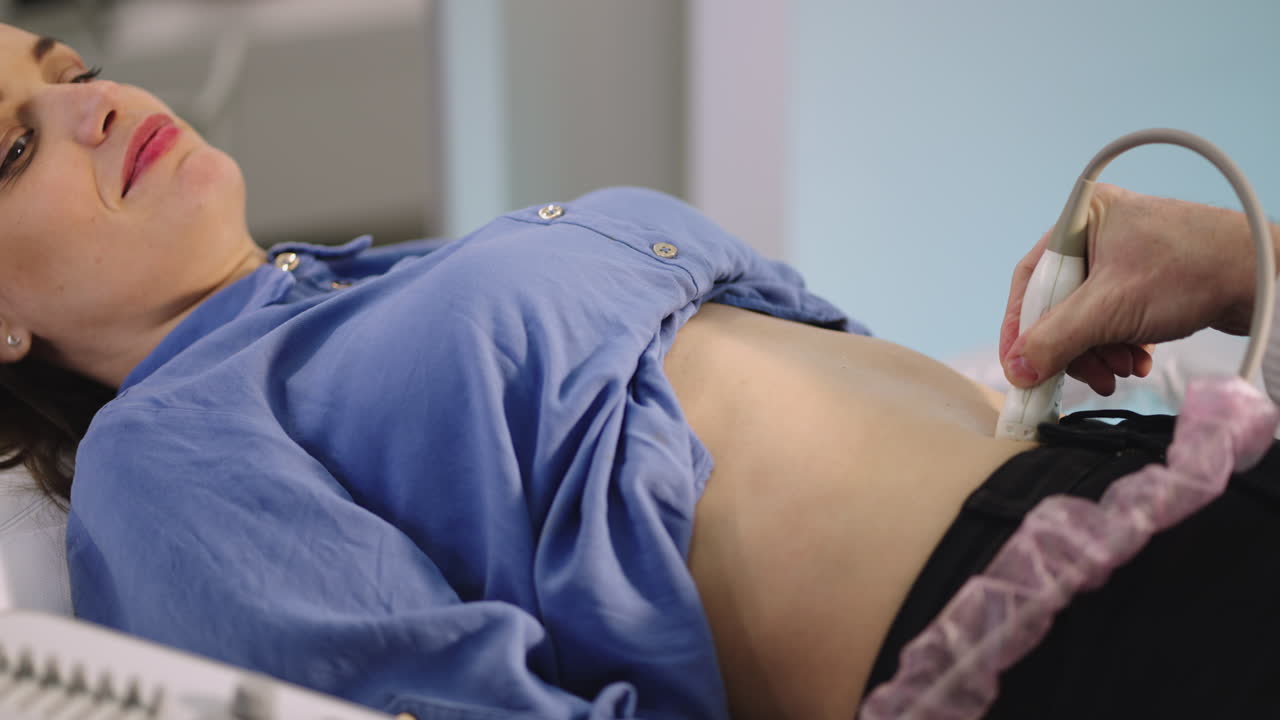Woman Undergoing Abdominal Ultrasound Examination