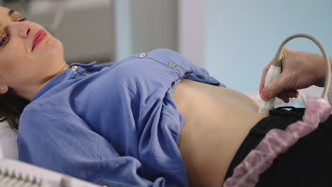 woman undergoing abdominal ultrasound examination