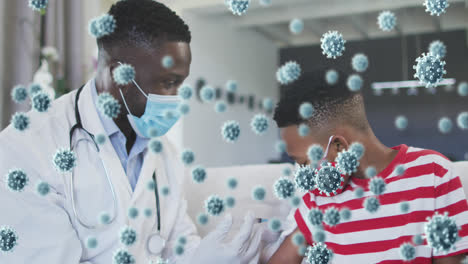 animation of covid 19 cells over african american boy in face mask receiving vaccination