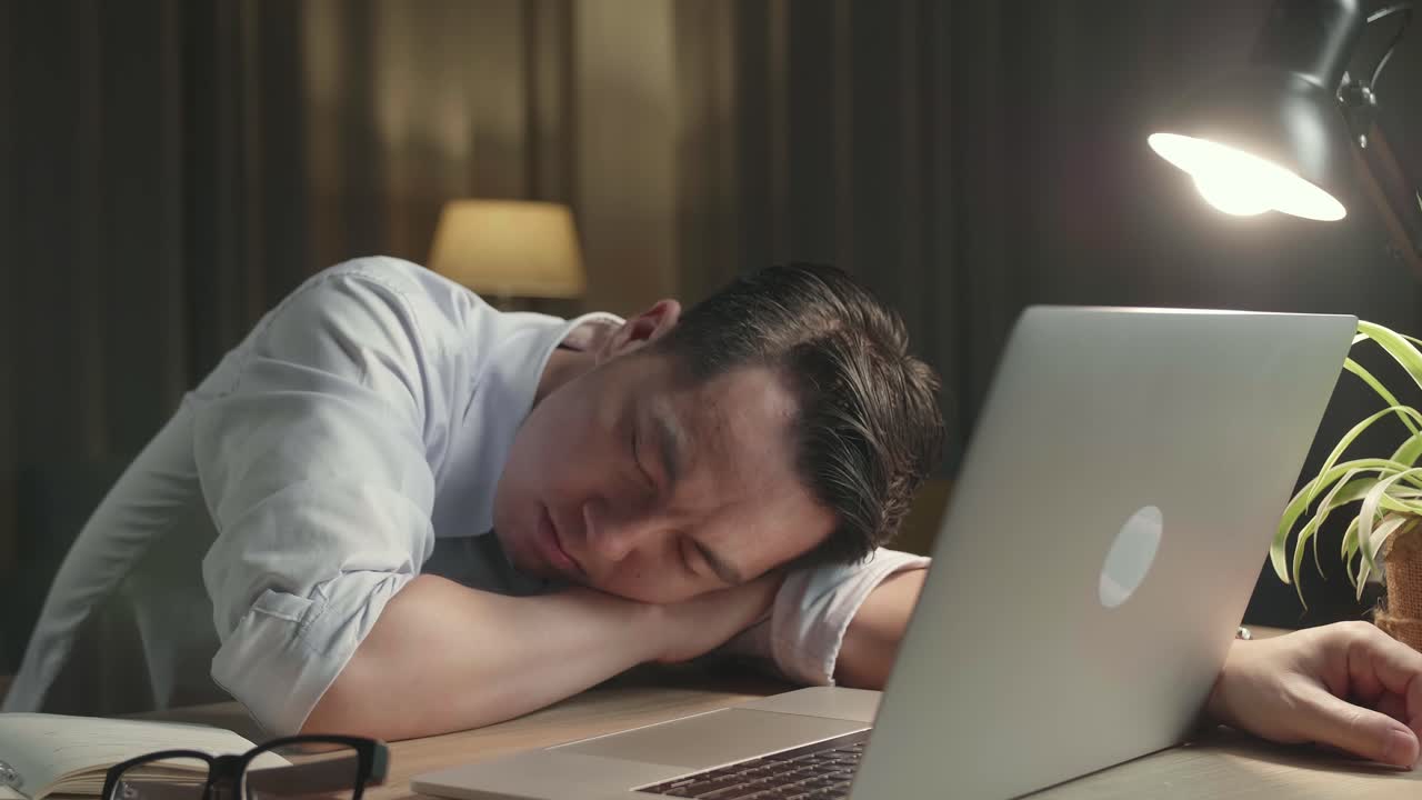 Tired Man Napping at His Desk