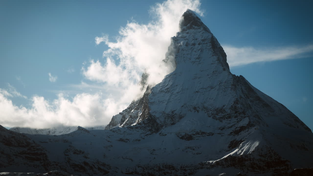 Majestic Snow-Covered Mountain Peak with Clouds