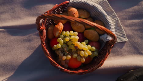 picnic basket with fruit and pastries