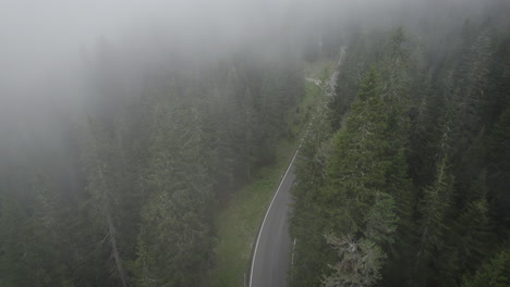 car drives up passo di giau in misty conditions