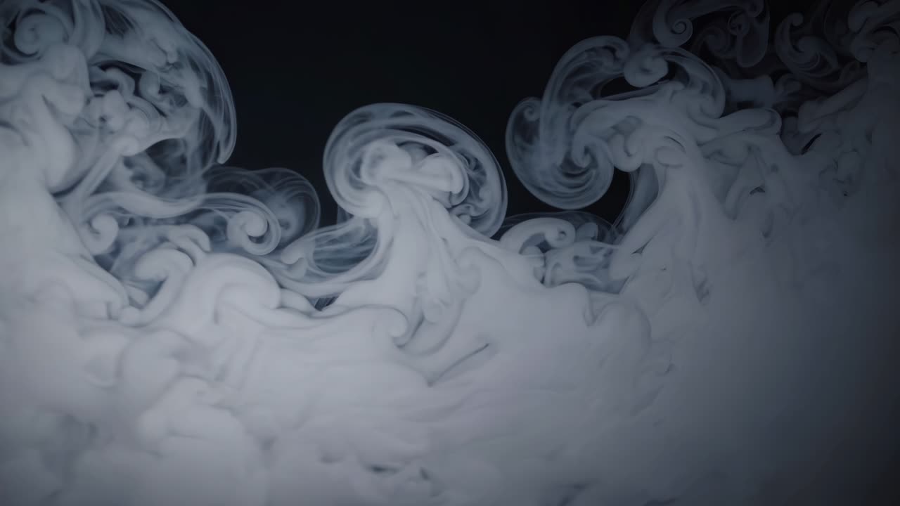 Abstract video of swirling white smoke against a dark background, captured from a side angle