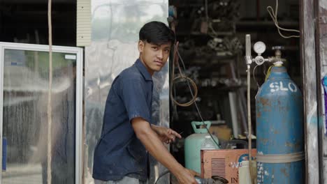 technician working with tools in a metal workshop
