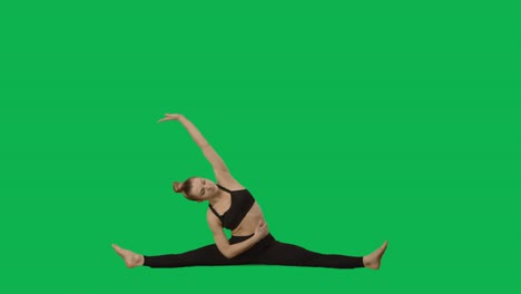 woman doing yoga and stretching on green screen