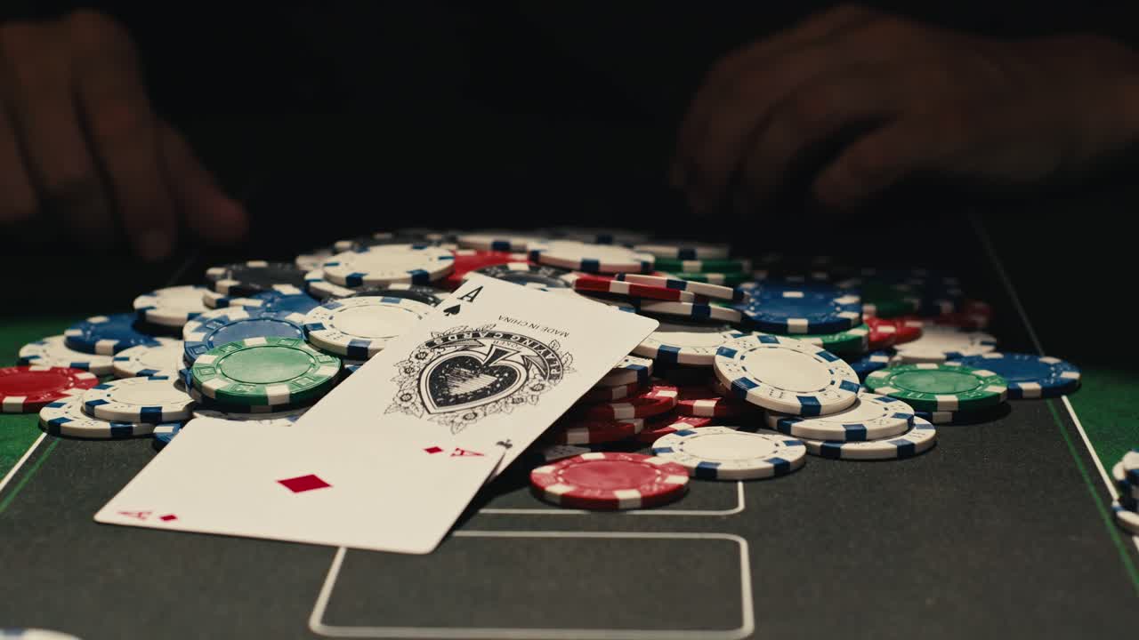 Hands managing poker chips on green table, reflecting intense poker gameplay with the element of chance and skill