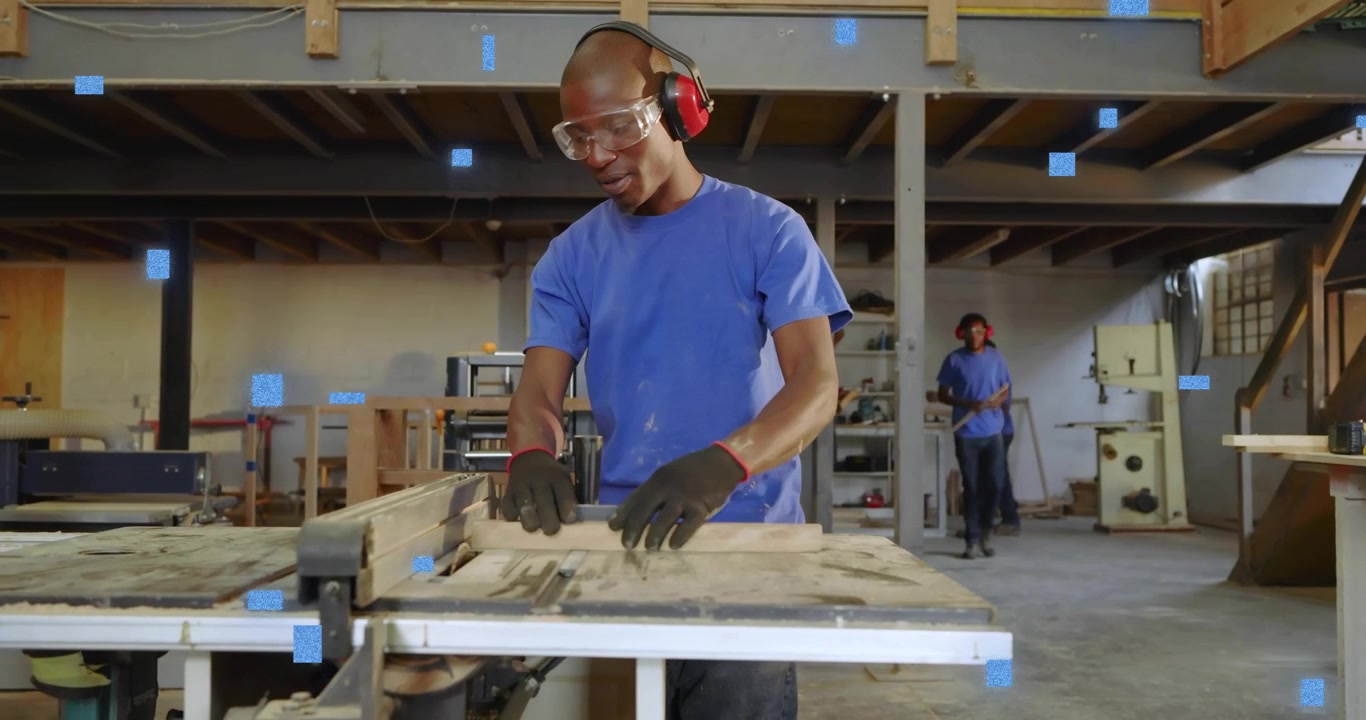 Carpenter adjusting hearing protectors feeding planks into woodshop saw with animated safety icons