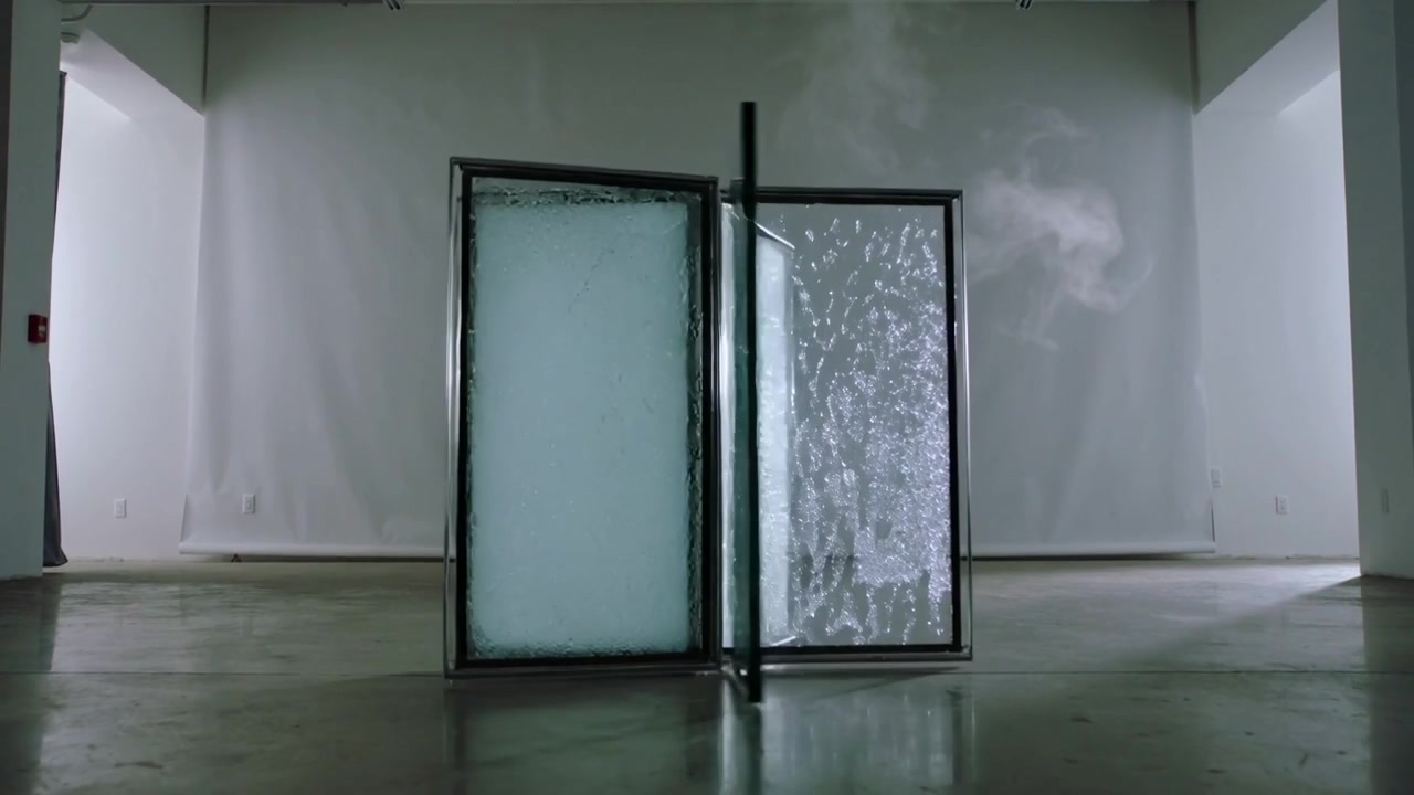 Rotating metal-framed glass panels on supports reacting to vapor plume rising in gallery