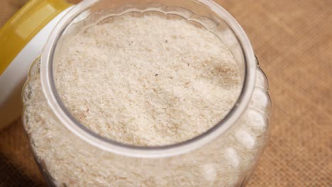 psyllium seeds in a glass container on table