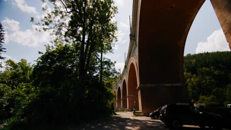 Viaduct-Schwarza-between-big-trees-and-sun-shining-in-the-background-in-Austria