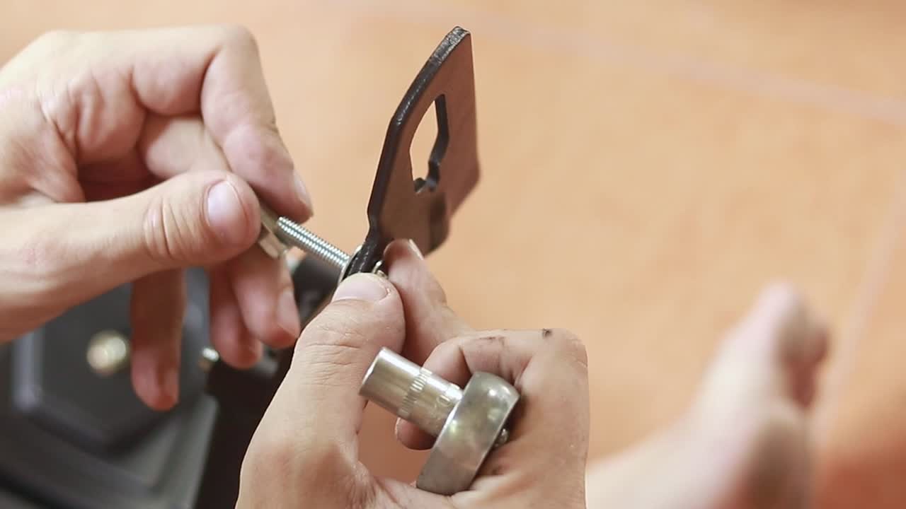 Close up to hands assembling a mechanical parts of a motorcycle using a wrench showing maintenance job