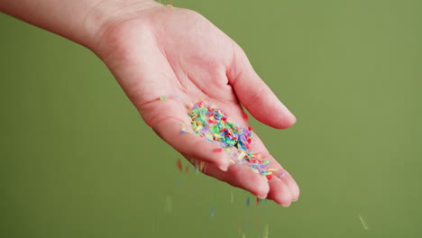 hand throwing colorful confetti