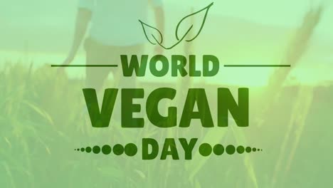 animation of world vegan day text over caucasian man walking over fields and sunset in sky