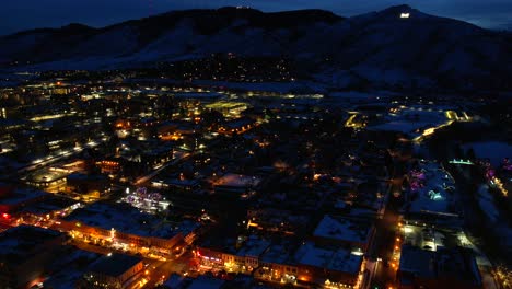 aerial drone sunset hyper-lapse of golden colorado mountian town in winter, night time