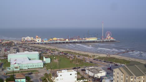 Drone-view-of-the-Pleasure-Pier-and-Galveston-Beach-in-Galveston,-Texas