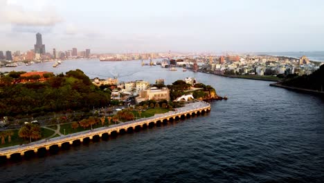 Coastal-city-skyline-at-sunset-with-bustling-harbor-and-green-park