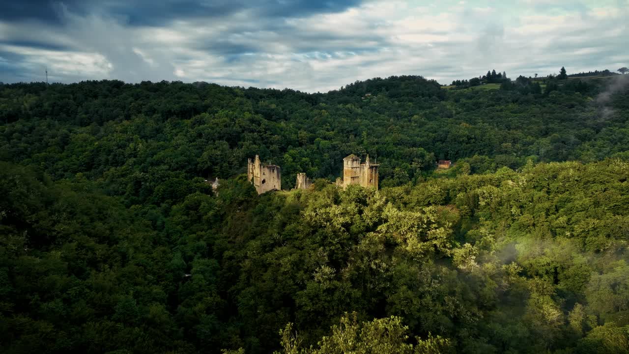 Long and large aerial view of a ruined medieval castle in France.