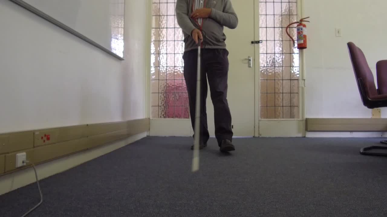 Blind man walking with a cane