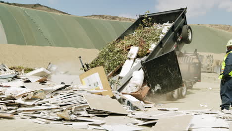 waste inspector overseeing debris unloading at landfill