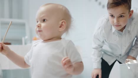 cute baby boy playing tinsel in living room. closeup serious small kid.