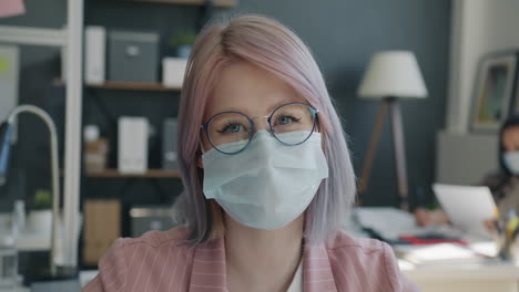 woman wearing a mask in a modern office