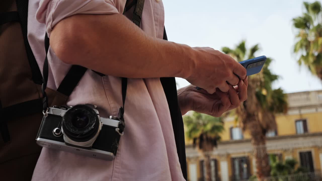Man tourist using smart phone searching location in map application online close up macro. Backpacker using GPS to find destination on vacation. City or Forest hiking, walking in europe