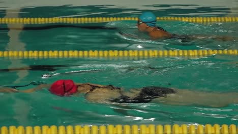 the woman was exercising in the swimming pool