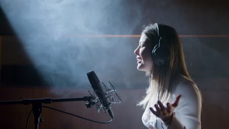 beautiful female singer working in music studio