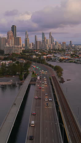 aerial view of city bridge with traffic at dusk