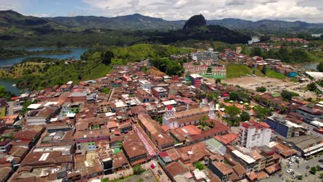 guatape colorful village and peñol rock in background