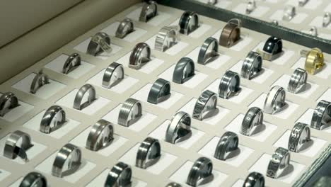 gold, silver, copper wedding rings on display at high end jewellery shop.