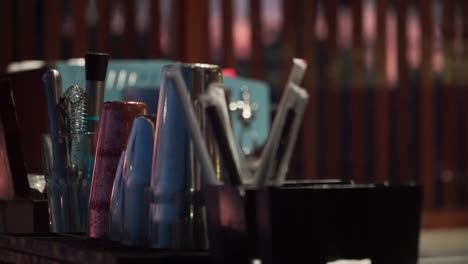 Interior-of-the-bar-in-the-night-with-wooden-counter-table-and-equipment-for-making-drinks