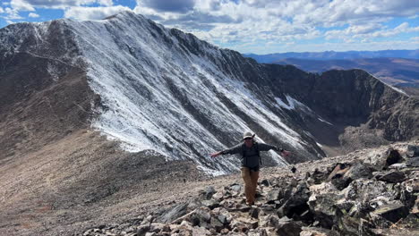 hiker on mount lincoln loop kite lake trail hiking 14er rocky mountains colorado dusting bross cameron democrat grays torreys quandary mountaineering peaks fall first snow dusting blue sky morning pan