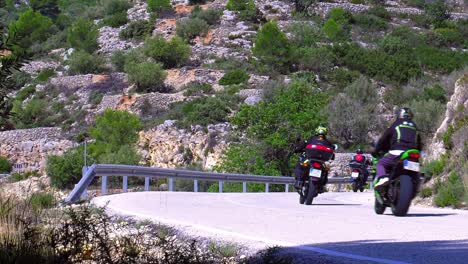 Motorbikes-on-a-bend-in-mountain-road,-Spain