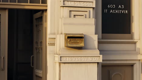 building facade with open door and mailbox
