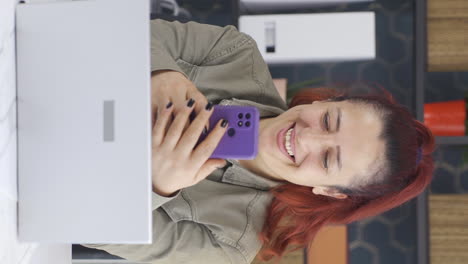 vertical video of happy business woman using phone laughing.